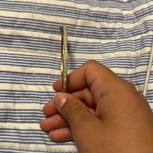 This is a bracelet with fake diamonds clips on the side gold plated some fading